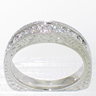 Platinum hand-engraved high-profile channel-band with 0.45 carats total weight of round melee diamonds